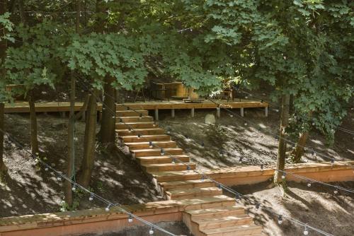 a wooden stairway leading up to a wooden deck at Downtown Forest Hostel & Camping in Vilnius