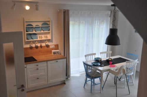 a kitchen and dining room with a table and chairs at Ferienhaus Wiekhus in Breege