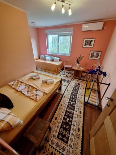a room with two beds and a couch at Nensi in Mostar