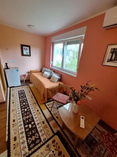 a living room with a bed and a table at Nensi in Mostar