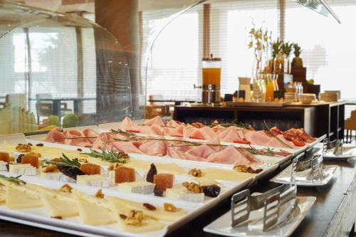 a buffet of meats and cheese on a table at Sercotel Sant Boi in Sant Boi del Llobregat