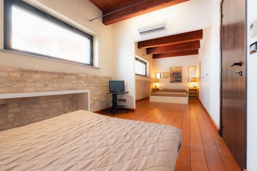 a bedroom with a large bed and a window at Residenza Michetti in Francavilla al Mare
