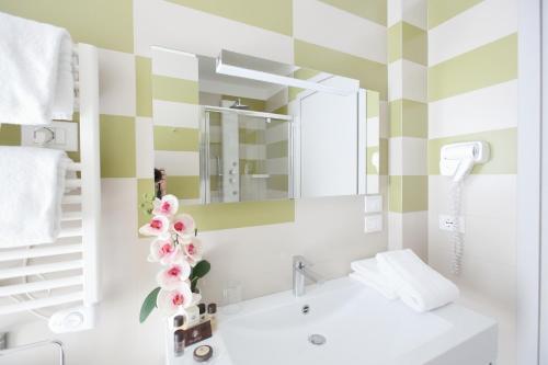 a bathroom with a sink and a mirror at Privilege Apartments in Vimercate