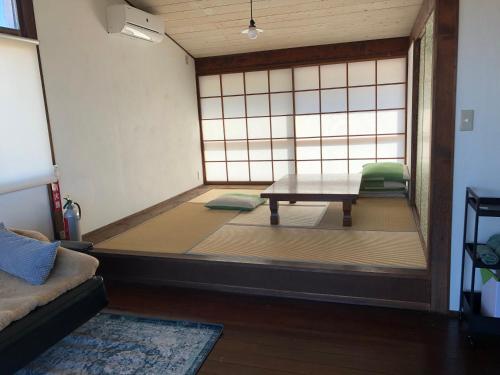 a room with a table and a chair in it at Emeraldia in Tateyama