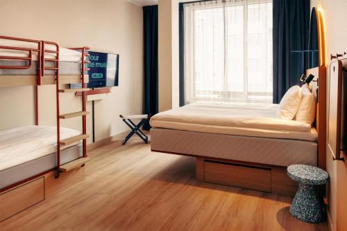 a room with two bunk beds and a window at Scandic Go, Eerikinkatu 30 in Turku