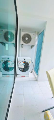 a bathroom with two machines in a room at Centrio 2 bed rooms 52 in Ban Lo Long
