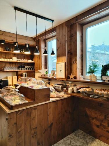 a restaurant with a counter with food on it at Wysoka noclegi ze śniadaniem in Krynica Zdrój