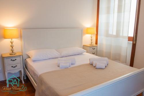 a bedroom with a large white bed with two night stands at Roan Home Pompei 2 in Pompei