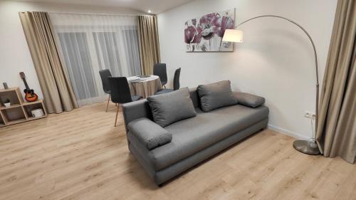 a living room with a couch and a table at Sunrise House in Žilina