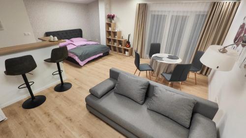 a living room with a couch and a bedroom at Sunrise House in Žilina