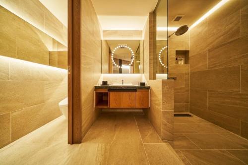 a bathroom with a sink and a mirror at The Blue House in Katsuura