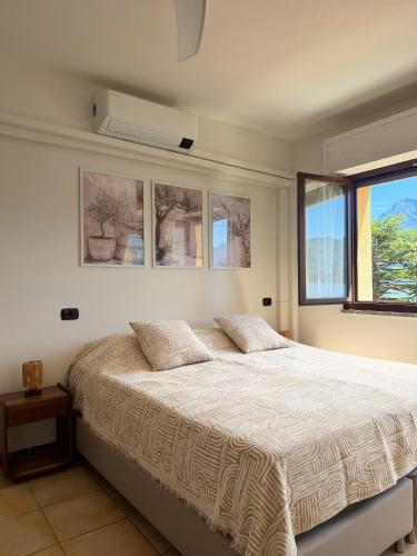 a bedroom with a large bed and a window at 2-Bedroom Airconditioned Lakeview Apartment in Acquaseria