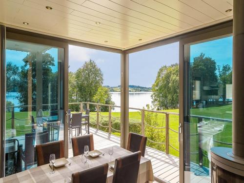 a dining room with a view of the water at Lakeside Stay with Sauna in Boussu-lez-Walcourt