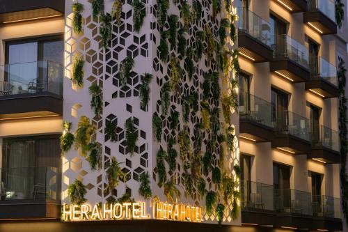 a building with a vertical garden on the side of it at Hera Hotel in Alexandroupoli