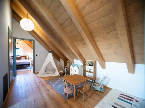 a room with a wooden table and a bedroom at Šimuntov dvor in Nová Baňa
