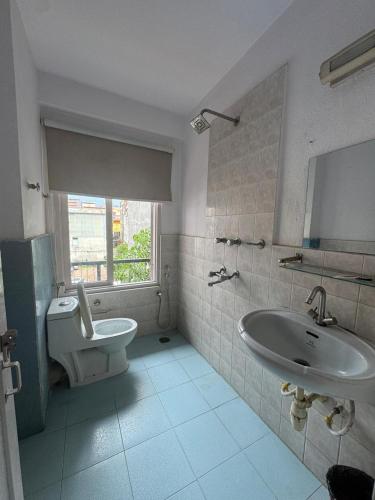 a bathroom with a sink and a toilet at Om Tara Guest House Pvt Ltd in Kathmandu