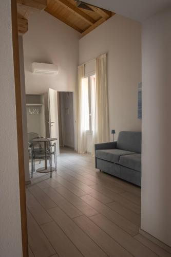 a living room with a couch and a table at OASI Apartment in Le Grazie