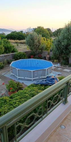 a large blue pool sitting on top of a garden at The house of joy in Egina