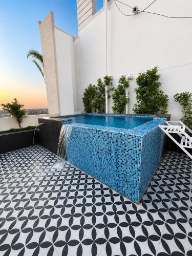 a swimming pool in the backyard of a house at Canvas and Cabana - Cabo in Sonīpat
