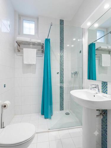 a bathroom with a sink and a shower and a toilet at Hôtel Au Val De Saône PARKING GRATUIT in Sathonay-Camp
