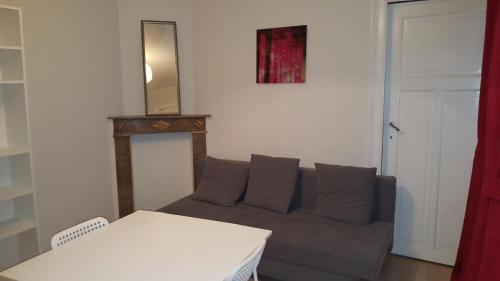 a living room with a couch and a mirror at Cool Central Apartment in Brussels