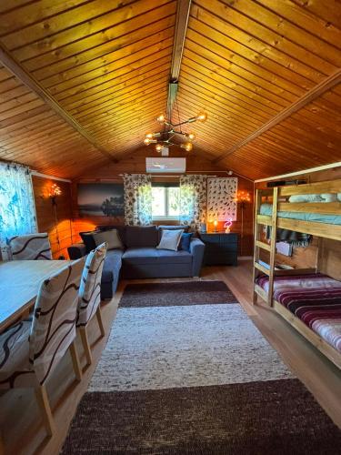 a bedroom with a bed and a couch in a room at Flamingon' in Undenäs