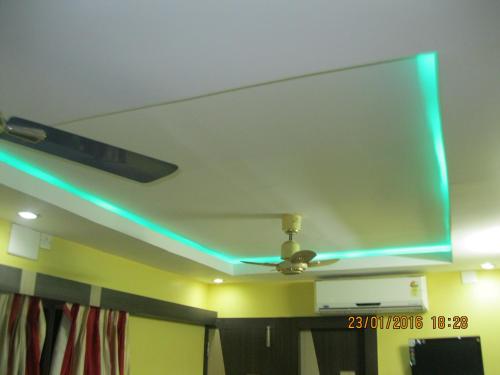 a ceiling with a green light on it at Hotel Srikrishna International in Tarapith