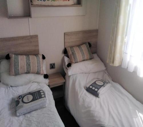 two beds in a small room with at Lymington in Leysdown-on-Sea