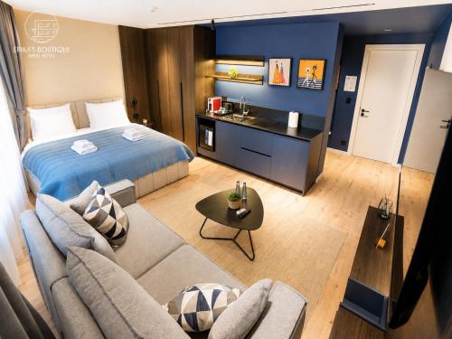 a bedroom with a bed and a living room at Erika's Boutique Hotel in Prishtinë