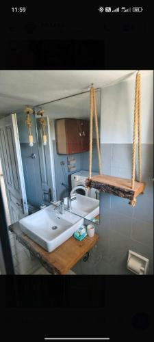 a bathroom with a large white sink and a mirror at villa sun view in Peratiá