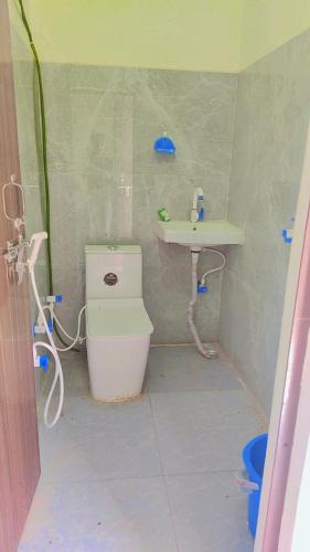 a small bathroom with a toilet and a sink at Shri om paradise inn in Mathura