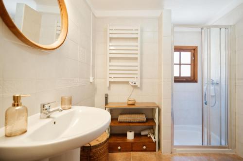 a white bathroom with a sink and a shower at Casa Rural El Traspatio in Granadilla de Abona