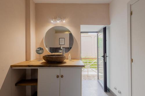 a bathroom with a sink and a mirror at Orotava The Home - Vacational rental with the lifestyle of 1700 and the comfort of 2022 in La Orotava