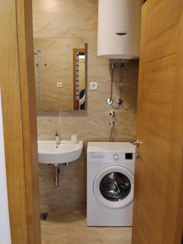 a bathroom with a washing machine and a sink at Apartman Vesna in Budva