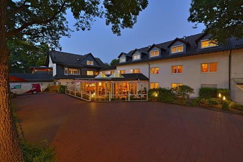 a large building with a courtyard in front of it at Hotel Pfeffermühle in Siegen