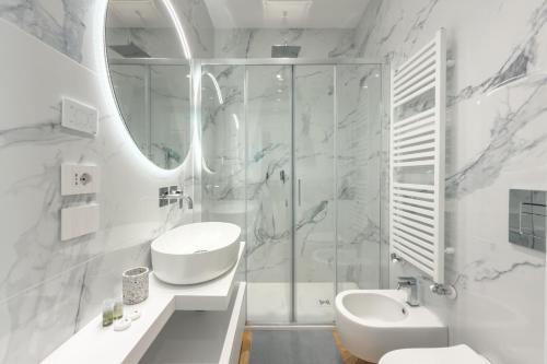 a white bathroom with a sink and a mirror at Casa Lux Forte dei Marmi in Forte dei Marmi