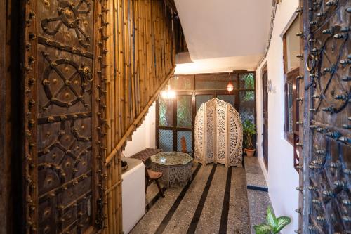 an entrance to a house with a wooden door at Le Fort Homestay in Jaipur