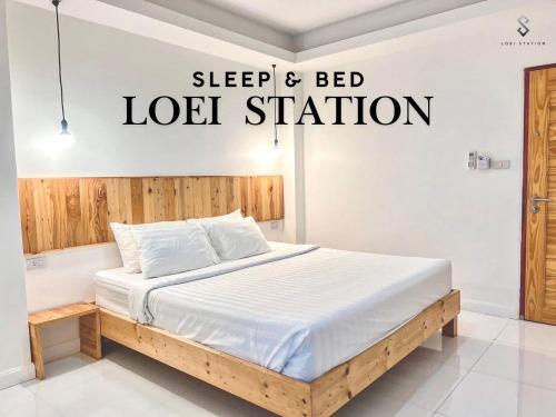 a bed in a bedroom with a sign that reads sleep and bed lease station at Loei Station in Loei