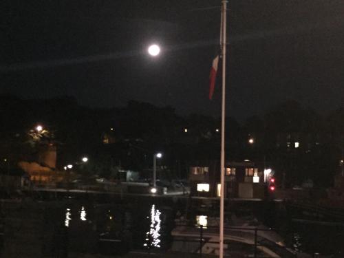 a boat in the water at night with a moon at The Chatsworth in Weymouth
