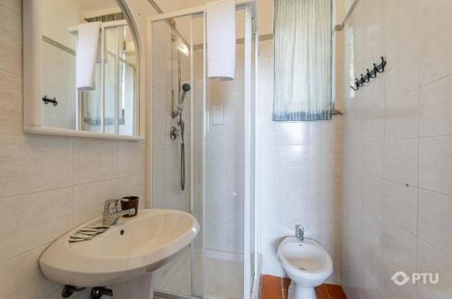 a bathroom with a sink and a shower and a toilet at PoloTuristicoUmbria Rustico con Piscina Vista Lago in Passignano sul Trasimeno