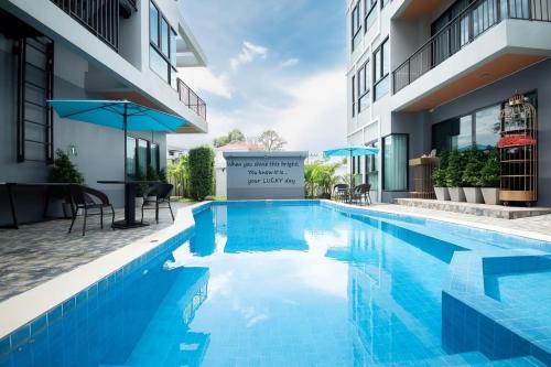 a swimming pool in the middle of a building at The Lucky Beach Ao Nang in Ao Nang Beach