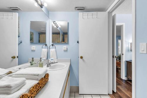 a bathroom with a sink and a mirror at Caprice 501 in St. Pete Beach