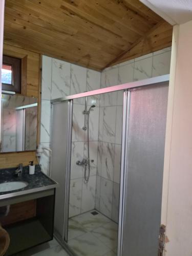 a bathroom with a shower and a sink at Azra Villas in Cıralı