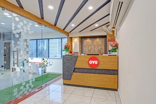 a lobby with aqo counter in a building at Hotel O Max Inn in Ahmedabad
