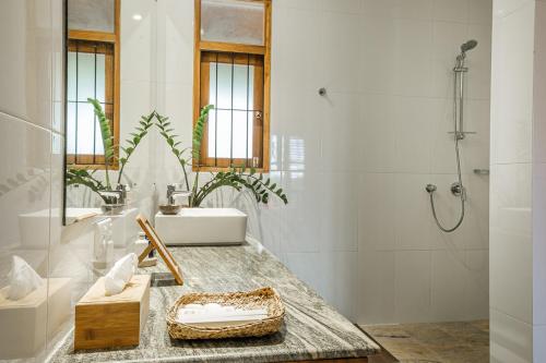 a bathroom with a sink and a shower at The Notary's House in Makandura