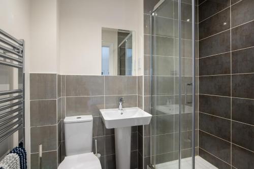 a bathroom with a toilet and a sink at Finest Retreats - Field View in Brackley