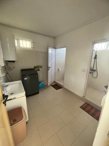 a large bathroom with a sink and a refrigerator at Casa Lotus in Pereybere