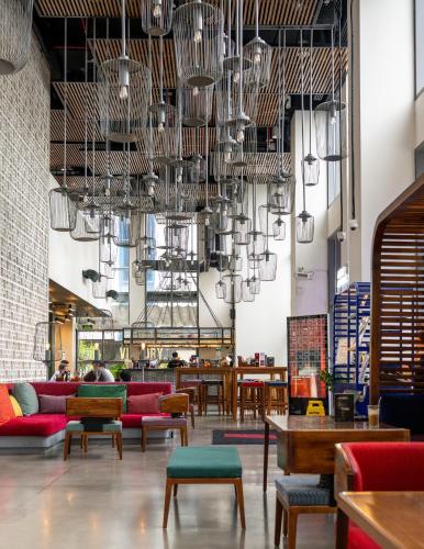 a large room with tables and chairs and chandeliers at Wink Hai Phong Centre, Unscripted by Hyatt - 24 Hours stay in Hai Phong