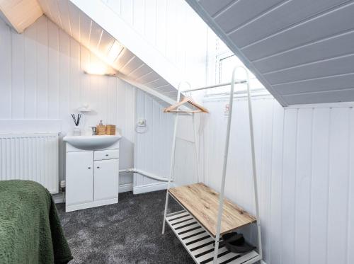 a bathroom with a sink and a ladder in a room at The Bay by Guestz in Morecambe