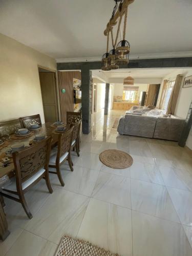 a living room with a table and chairs and a bed at Casa Lotus in Pereybere